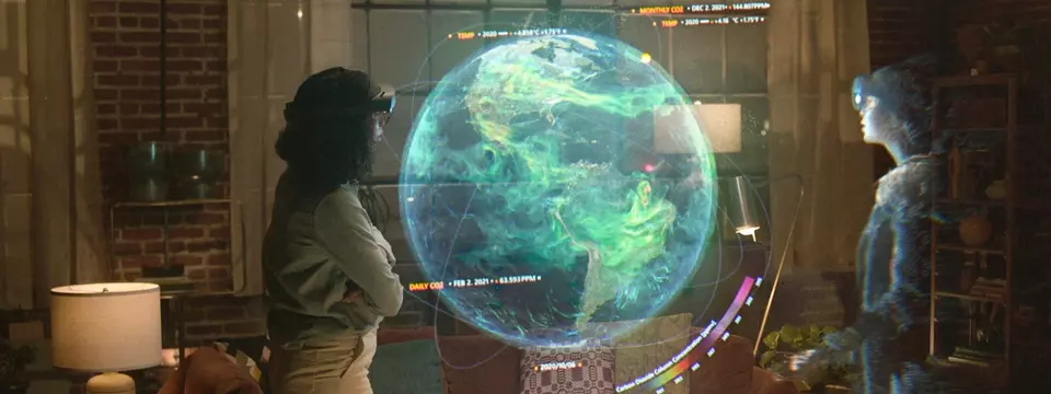 Person interacting with a mixed reality display of Earth using Microsoft Mesh, accompanied by a digital holographic humanoid figure.